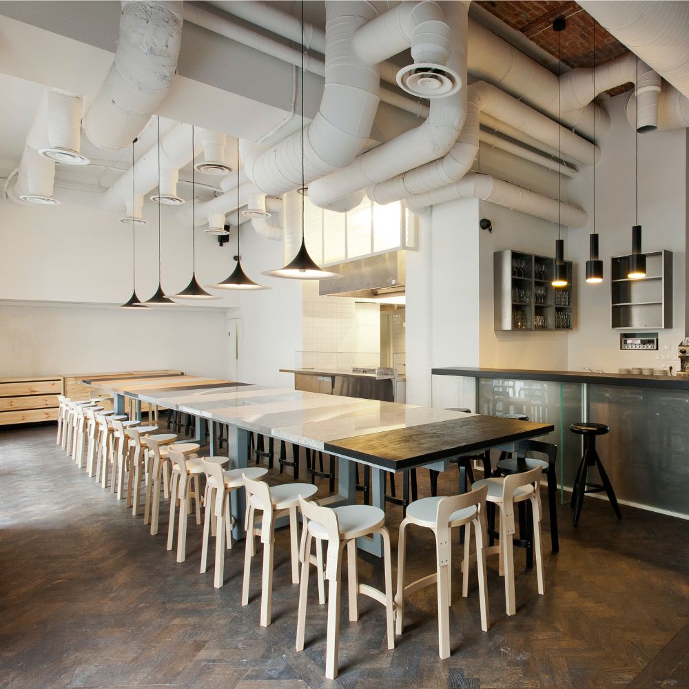 Artek Alvar Aalto K65 High Chairs in Modern Cafe with Grenade Lights and GUBI Semi Pendant Lights