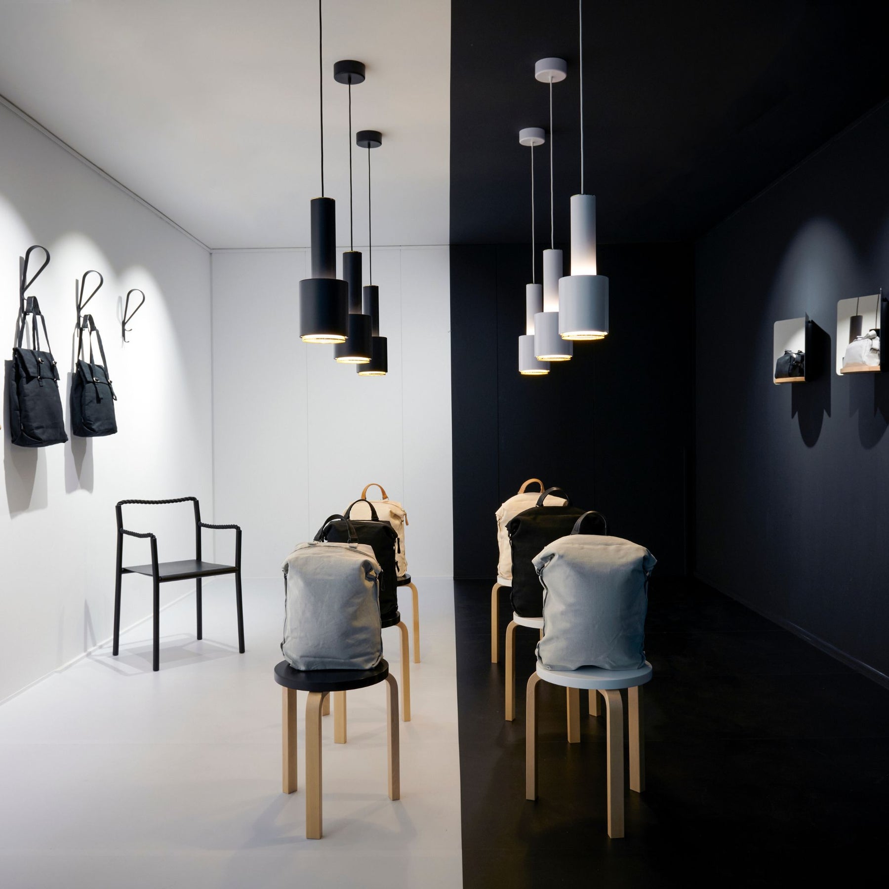 Artek Alvar Aalto Stool 60s in situ with Grenade Lamps and Backpacks in Geneva Fashion House