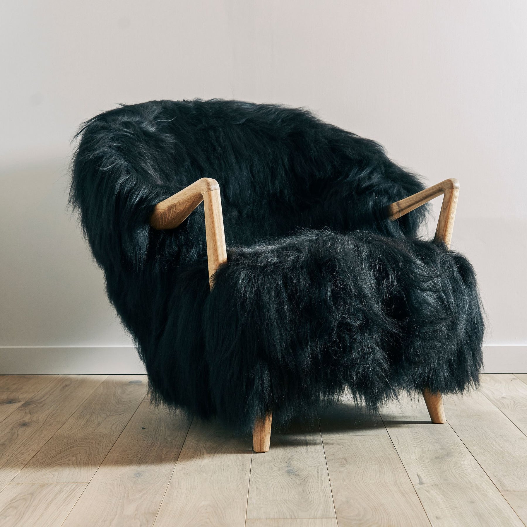 Eikund Fluffy Lounge Chair Black Sheepskin in Studio