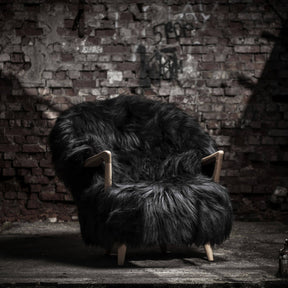 Eikund Fluffy Lounge Chair Black Sheepskin Oak Frame in Industrial Brick Loft