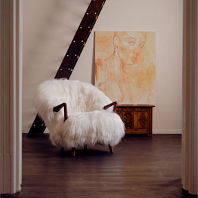 Eikund Fluffy Lounge Chair Natural White Sheepskin in Loft with Art