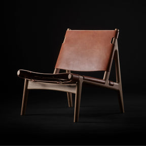 Eikund Hunter Chair Cognac Saddle Leather with Oak Oil Frame in Studio Black Background