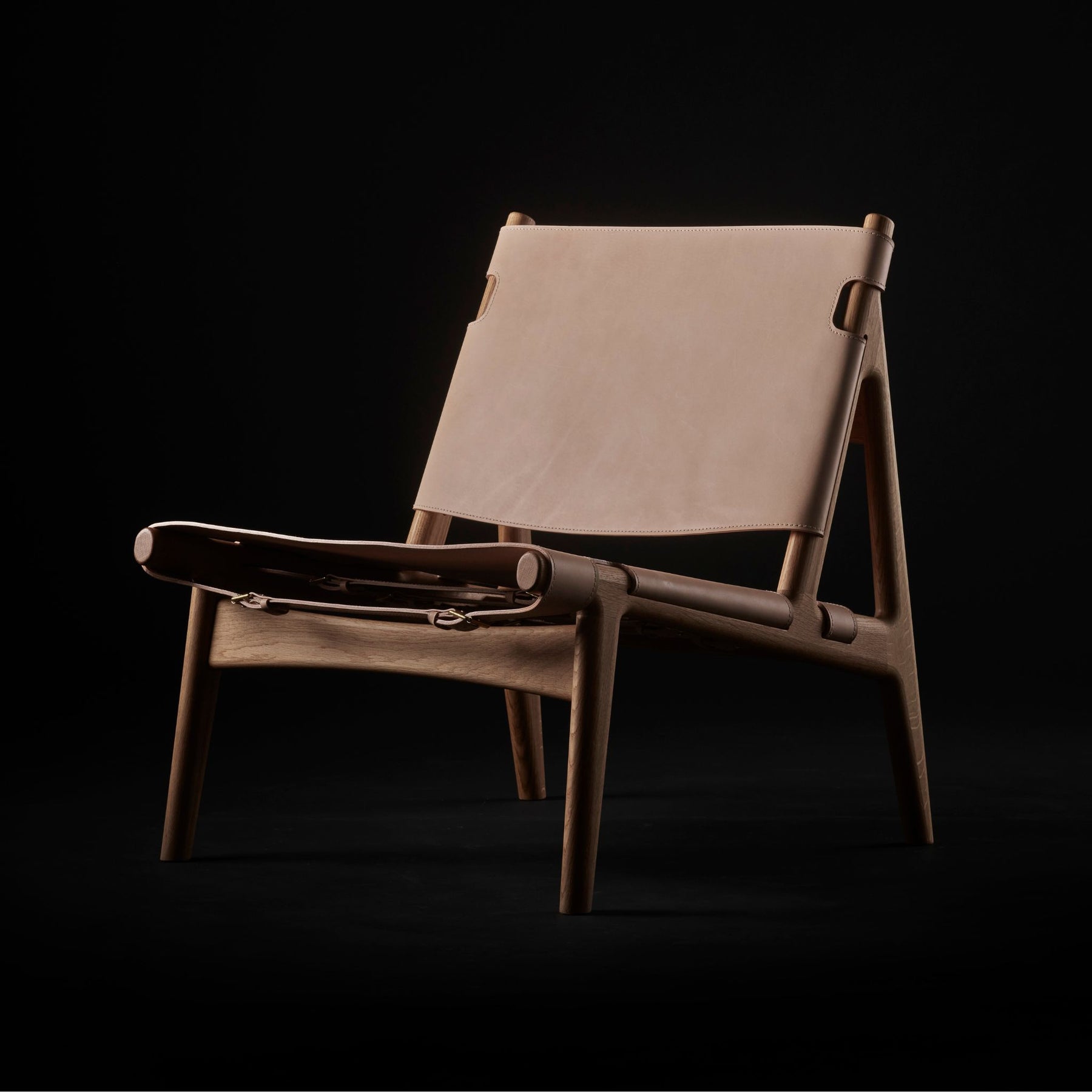 Eikund Hunter Chair Natural Saddle Leather with Oak Oil Frame in Studio Black Background