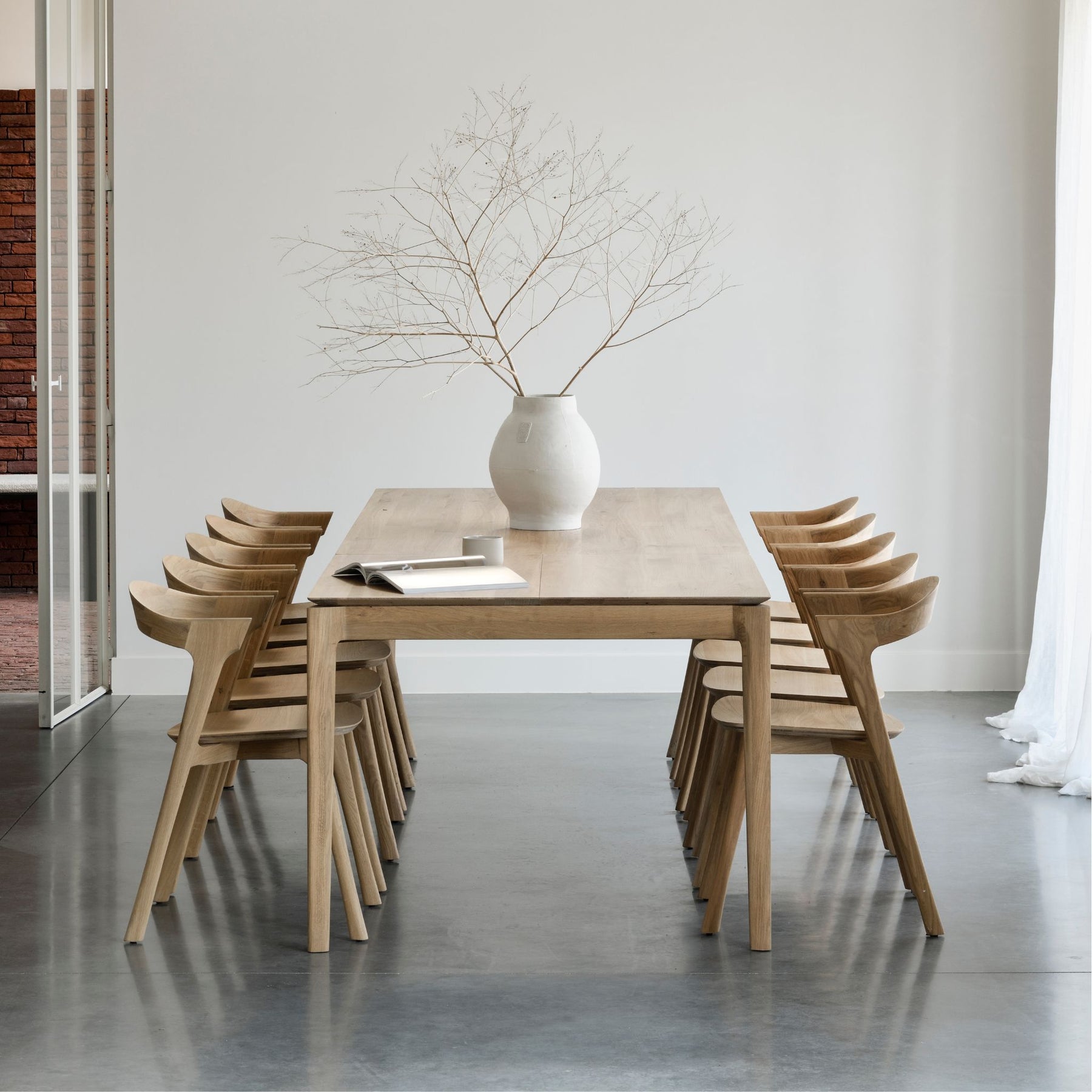 Ethnicraft Oak Bok Dining Table and Chairs in Light Filled Dining Room with Belgian Sheer Drapery