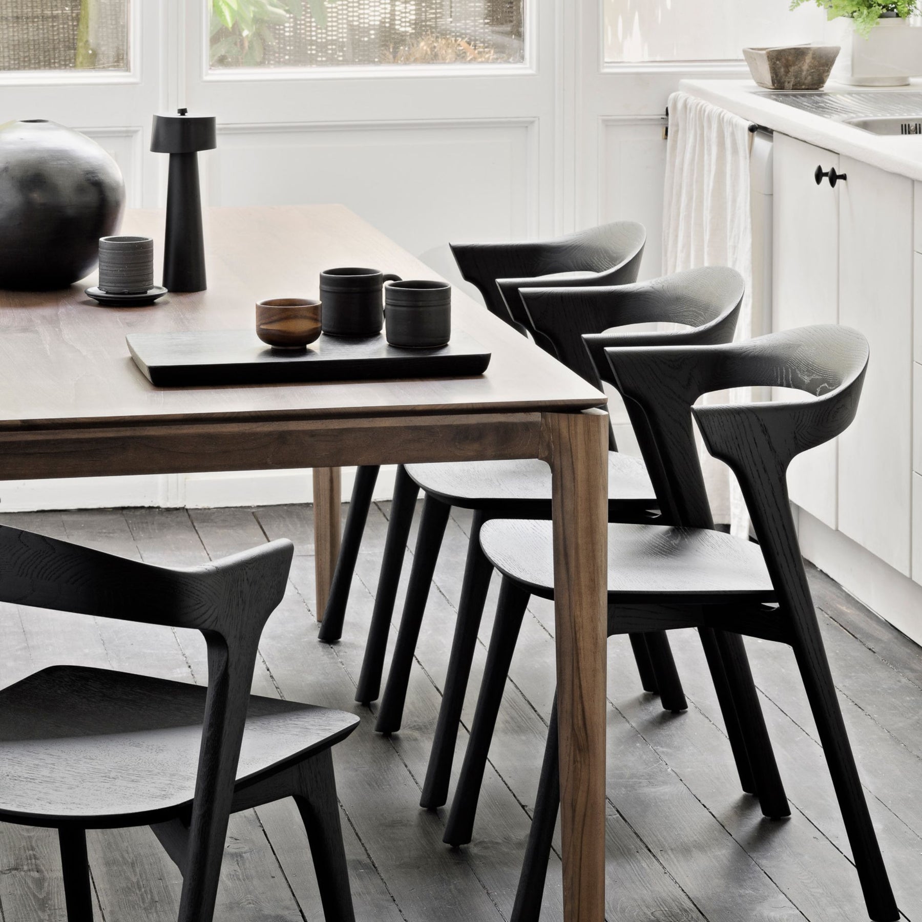 Ethnicraft Brown Varnished Teak Bok Dining Table and Black Oak Bok Dining Chairs In Situ