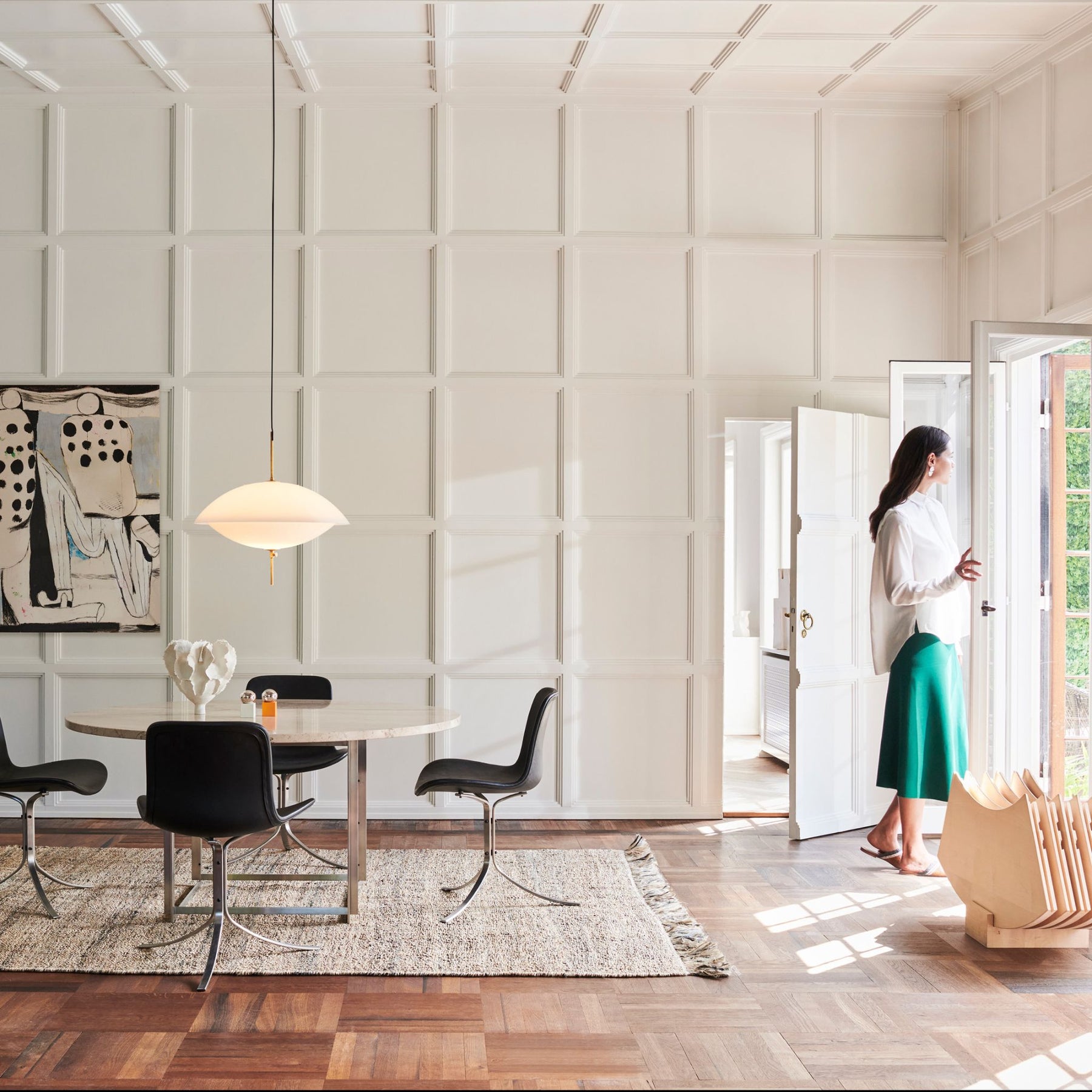 Fritz Hansen Clam Pendant over Poul Kjaerholm Dining Table in Room with Art