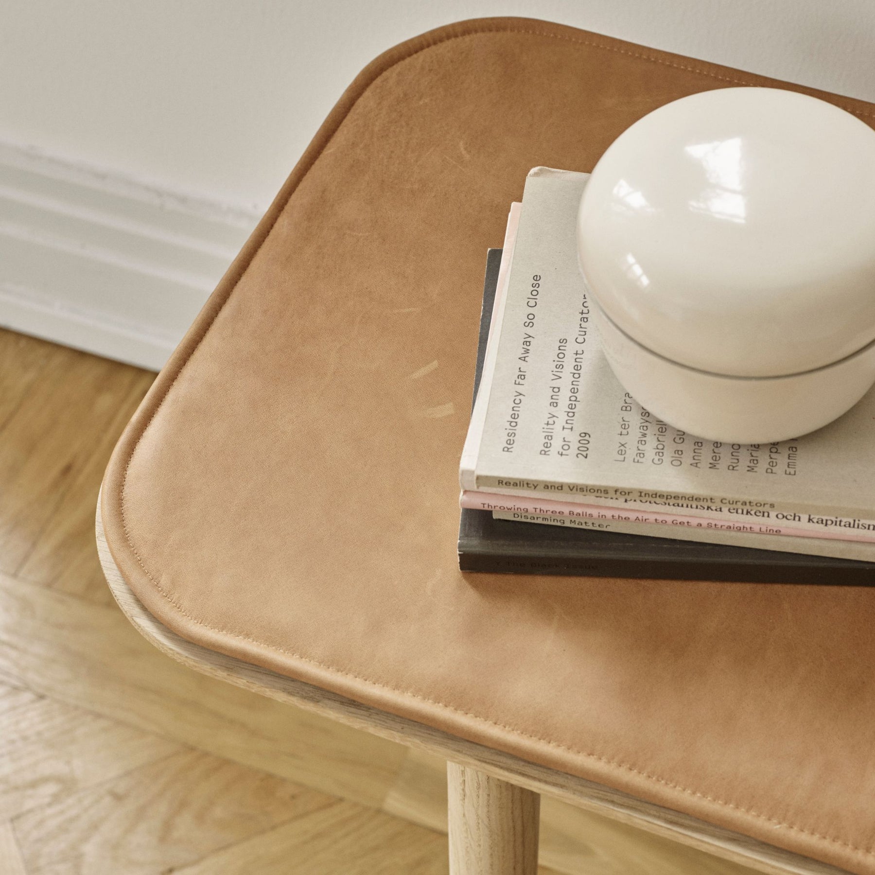 Fritz Hansen Skagerak Hven Bench with Leather Cushion and Stack of Books Detail