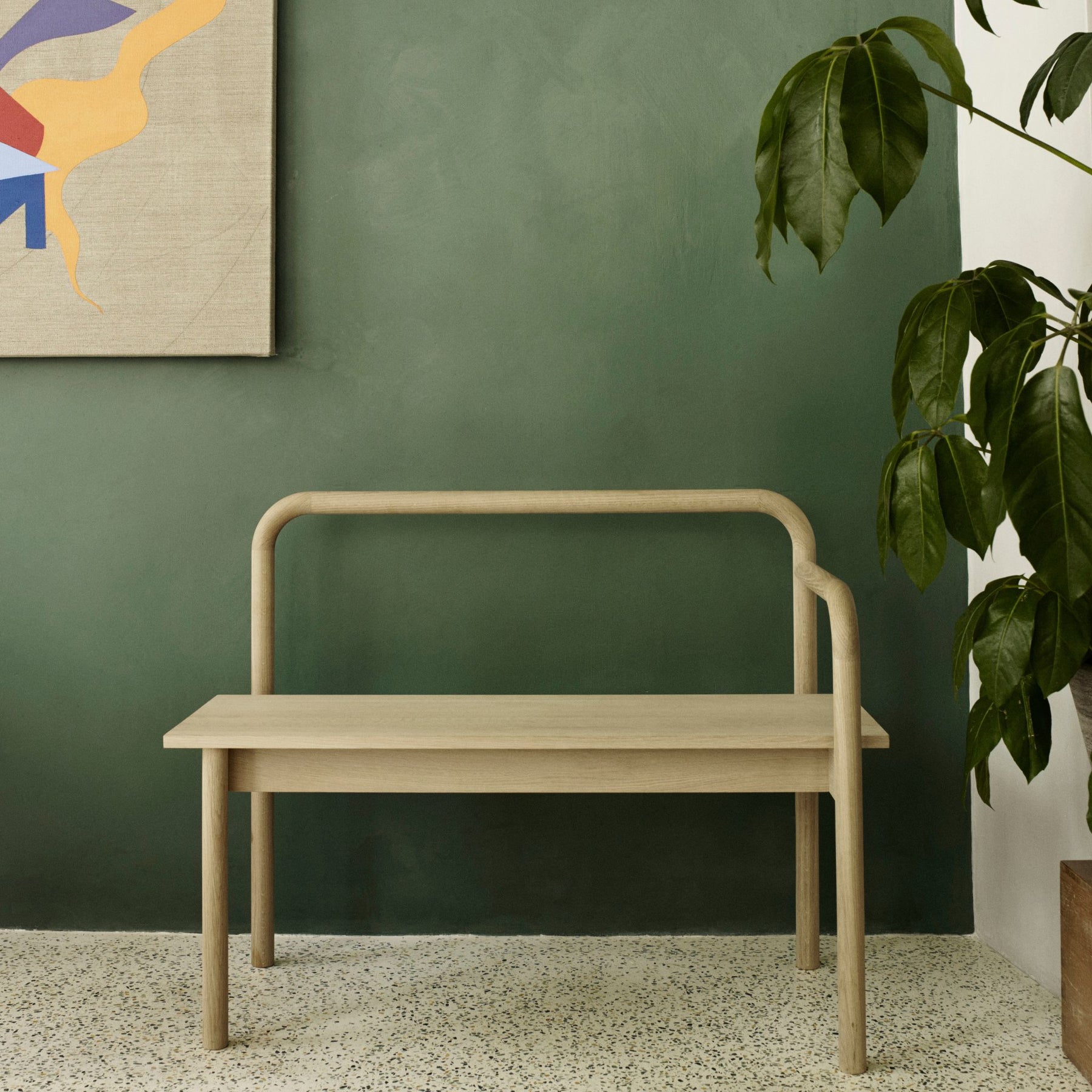 Fritz Hansen Skagerak Maissi Bench by Green Wall with Plant and Painting