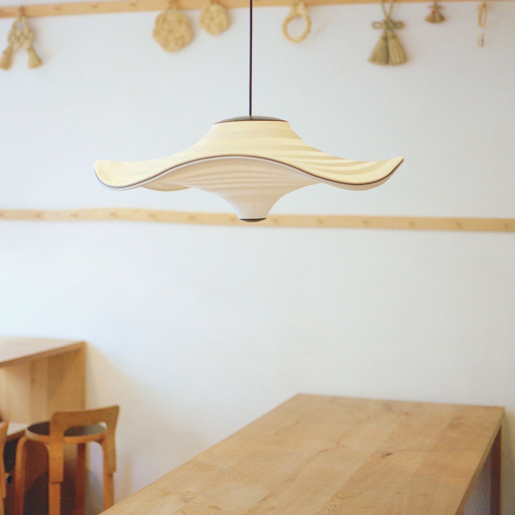 Made By Hand Flying Pendant in Copenhagen Cafe with Artek Counter Stools