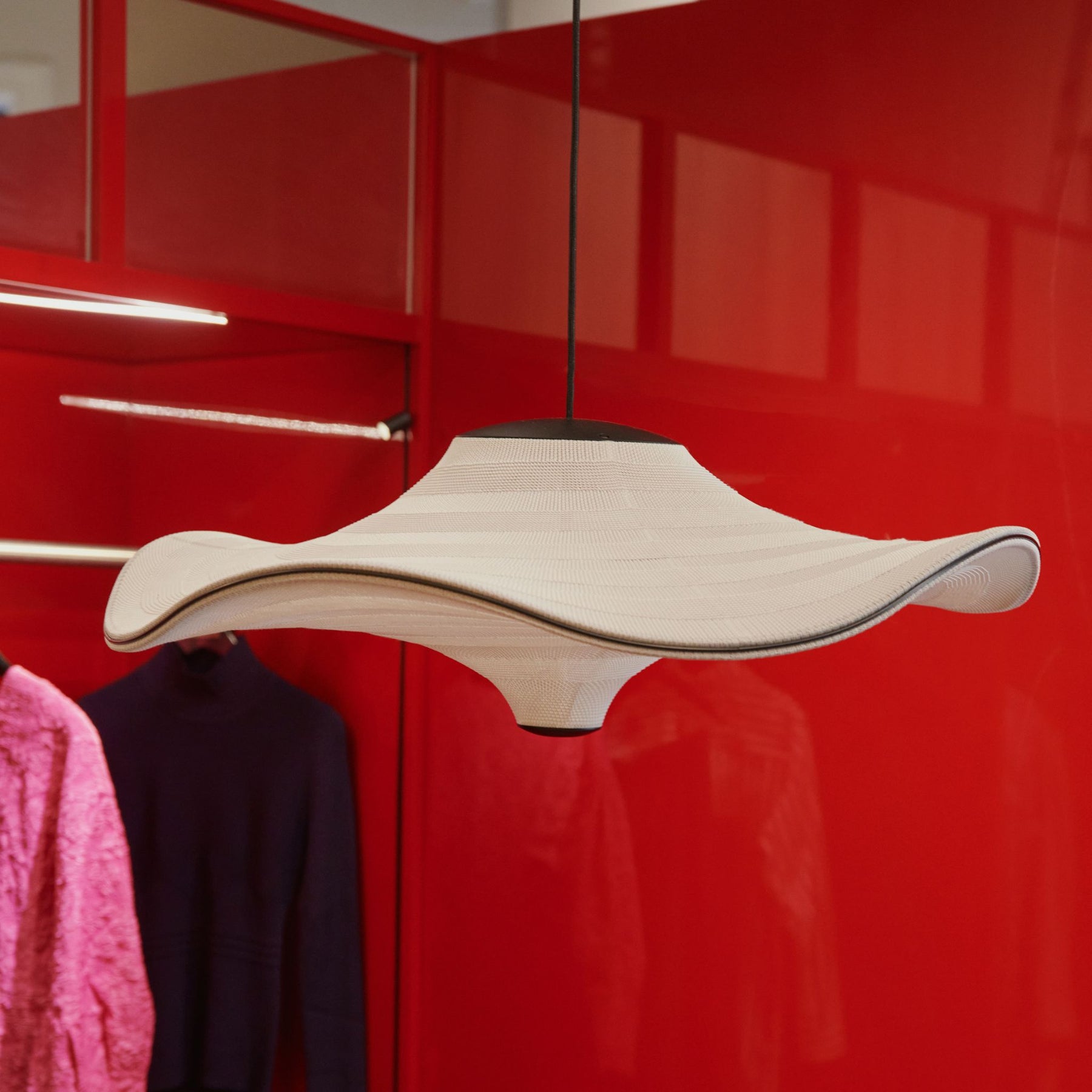 Made By Hand Flying Pendant by red lacquered wardrobe