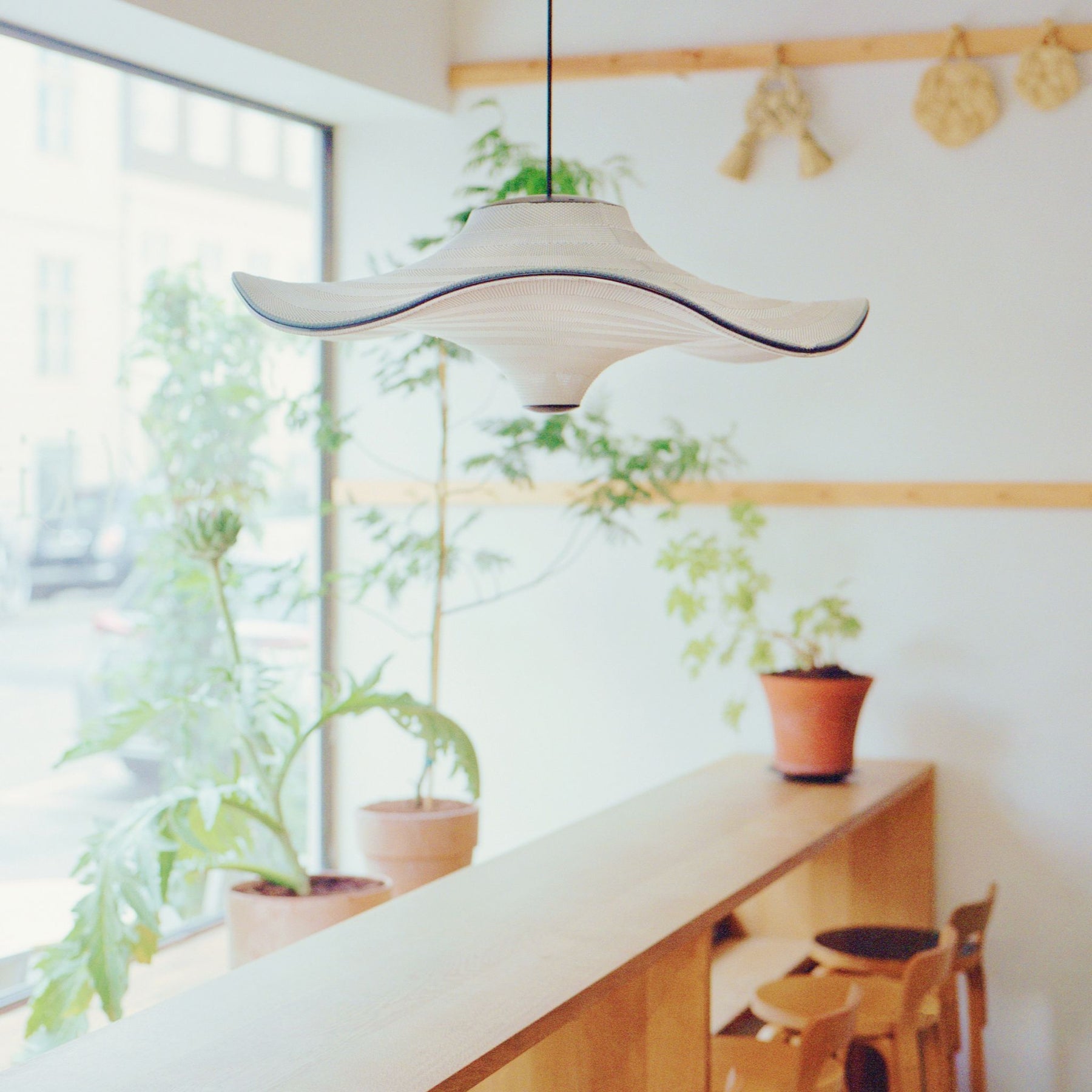 Made By Hand Flying Pendant in Copenhagen Cafe with Plants
