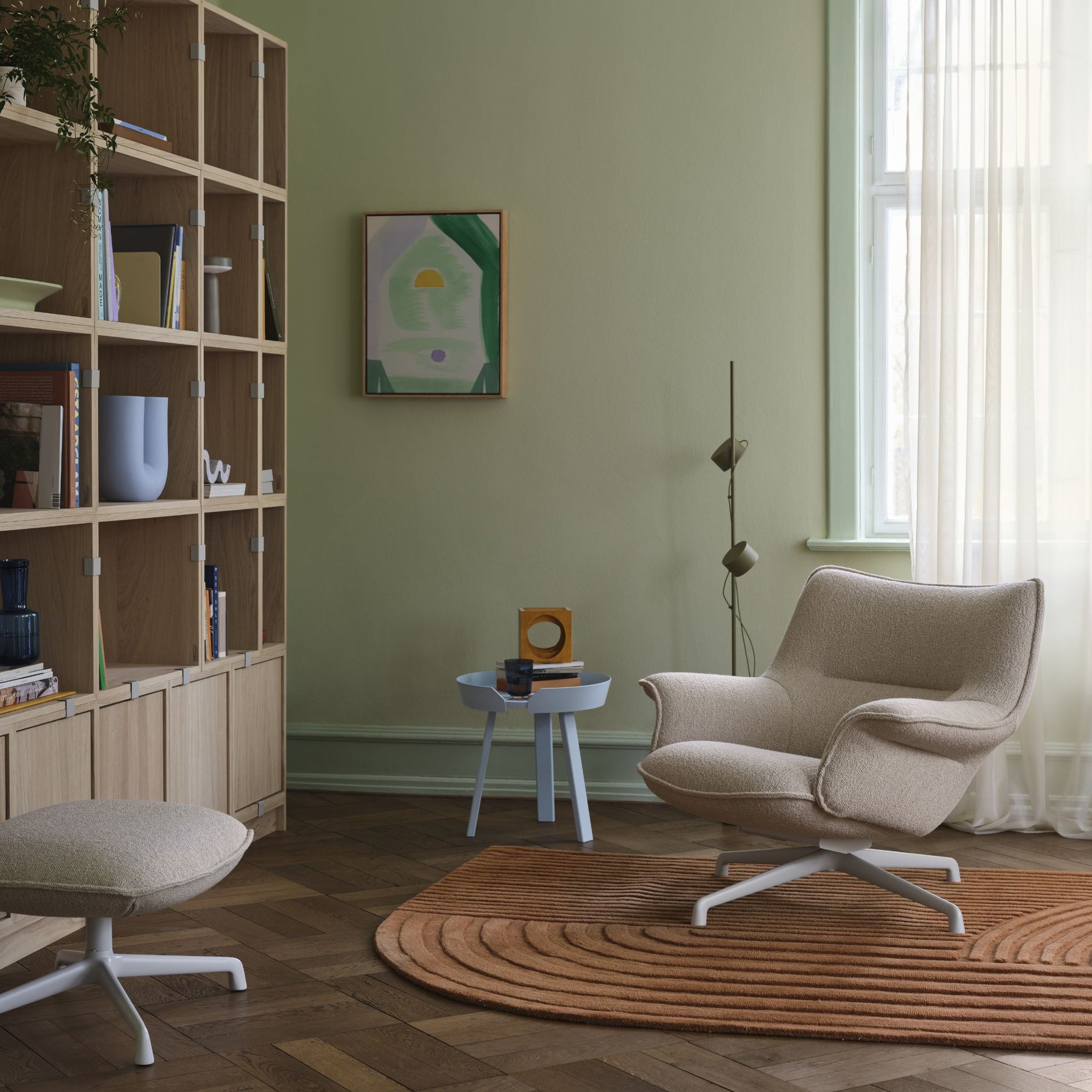 Muuto Doze Lounge Chair and Ottoman in Copenhagen Living Room with Revelo Rug Stacked Storage Around Side Table and Post Floor Lamp