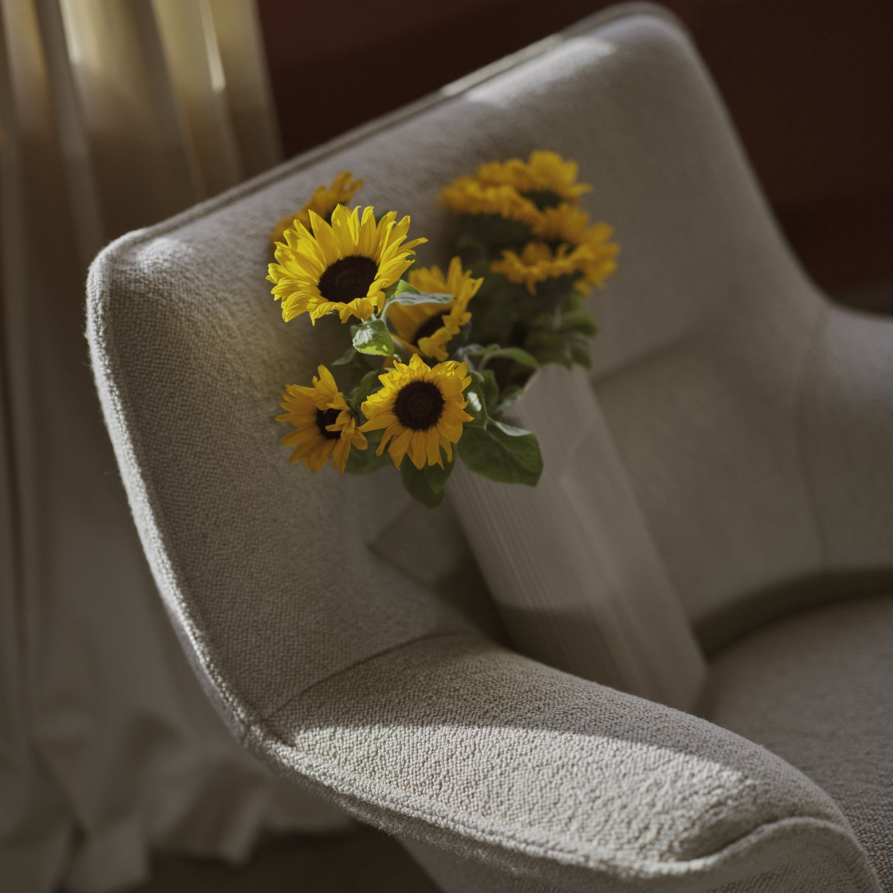Muuto Doze Swivel Lounge Lowback in Hearth 007 Styled with Ridge Vase and Sunflowers