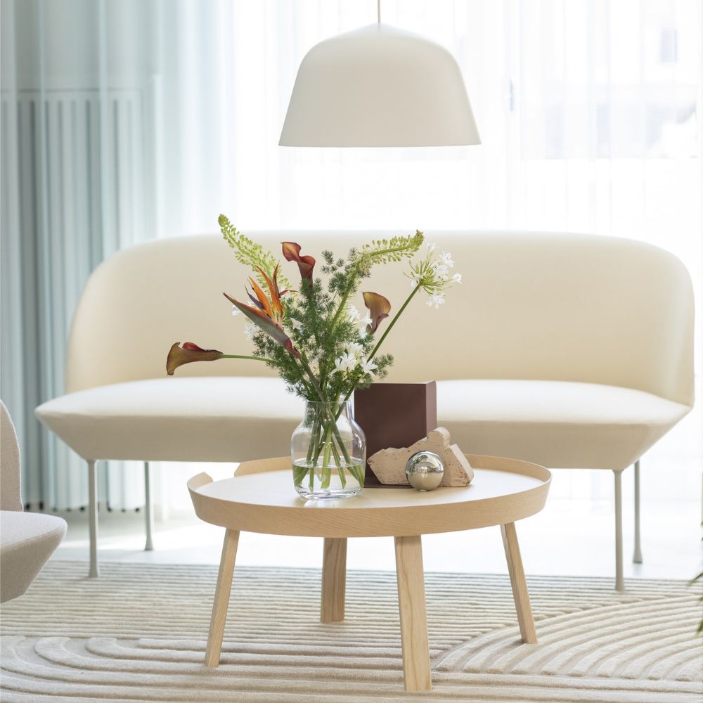 Muuto Oslo Sofa Cream in room with Revelo Rug, Around Coffee Table, and Ambit Pendant