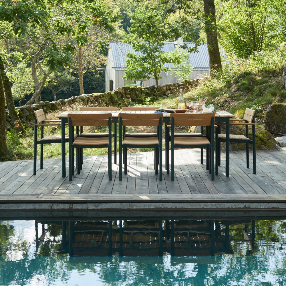 Pelagus Dining Table and Chairs Teak Hunter Green Outdoors by Pool with Reflection