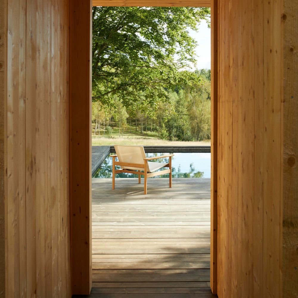 Pelagus Teak Lounge Chair through Pool House Hallway on Deck