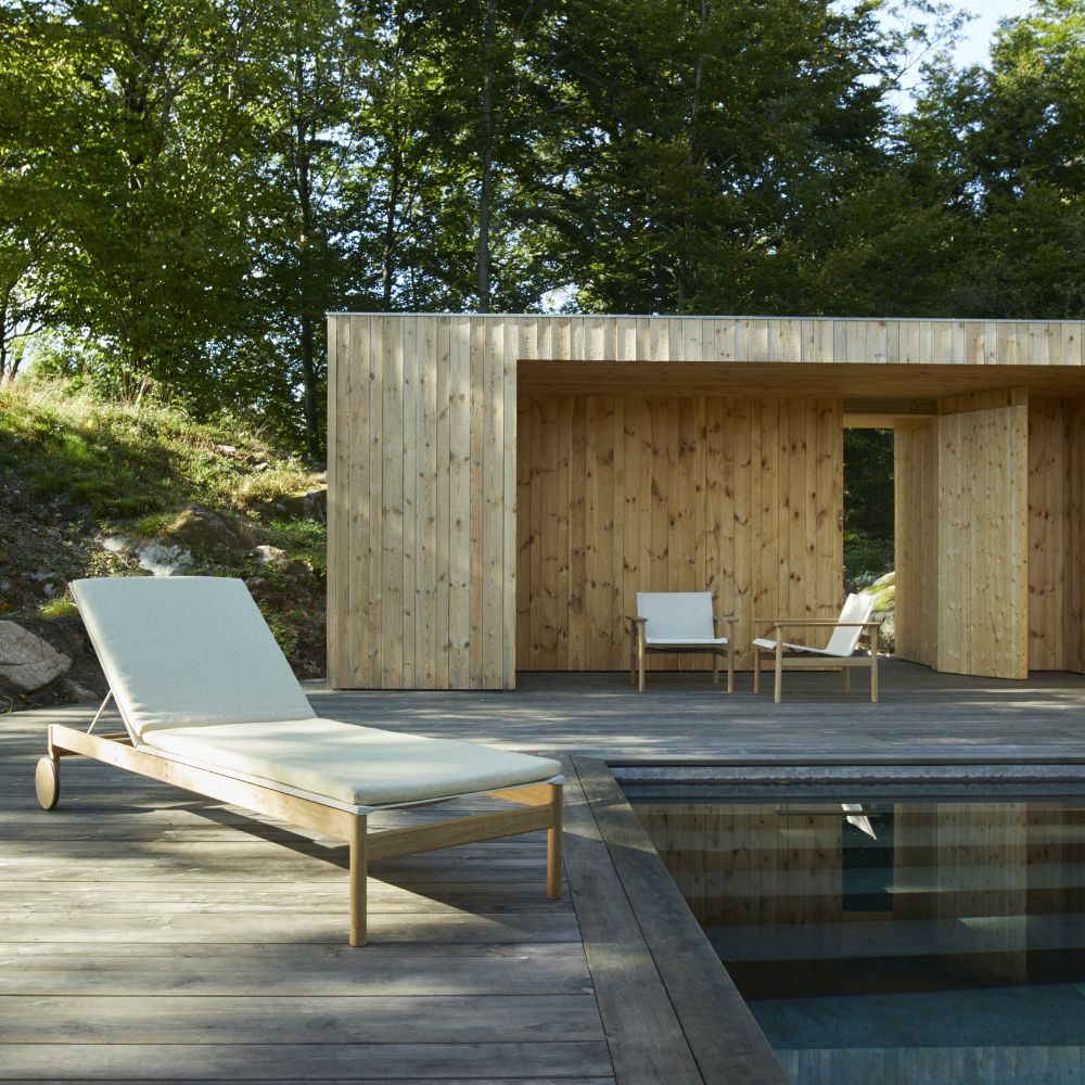 Pelagus Teak Lounge Chairs in background by Pool with Chaise