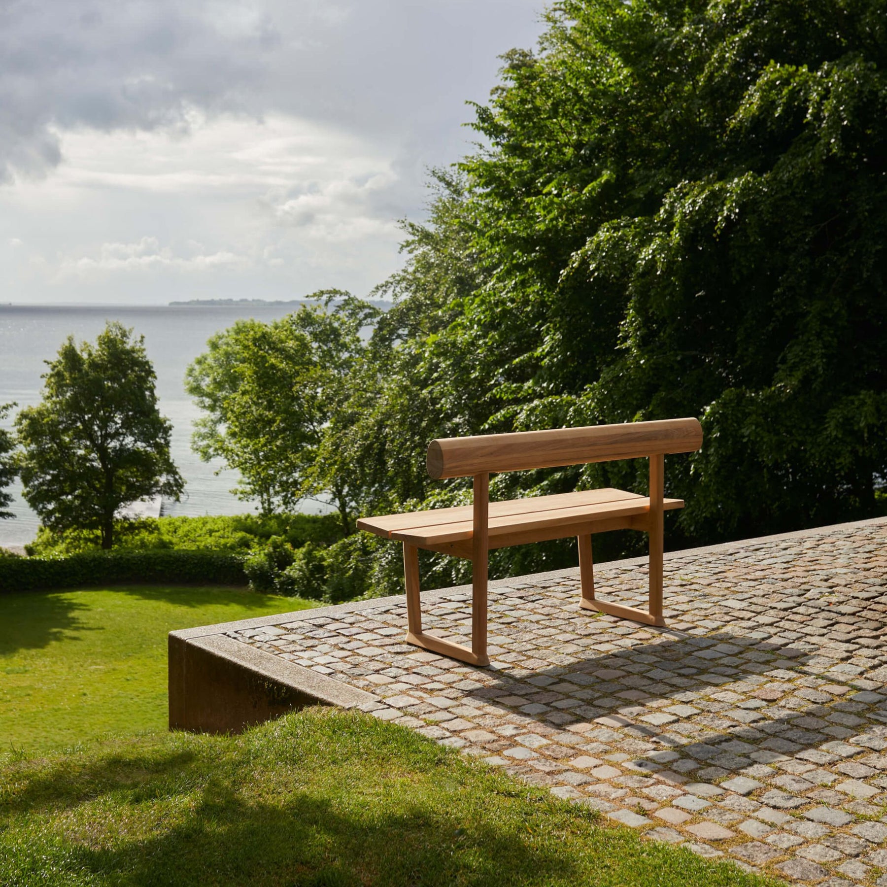 Fritz Hansen Skagerak Banco Bench on Cobblestone Terrace Overlooking Sea