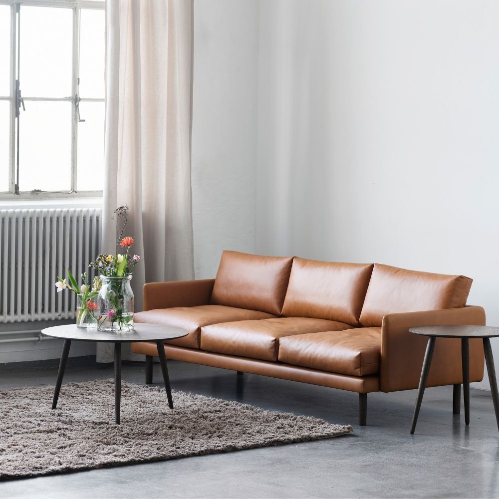 bruunmunch Emo sofa cognac leather styled in living room with PlayRound Coffee Tables
