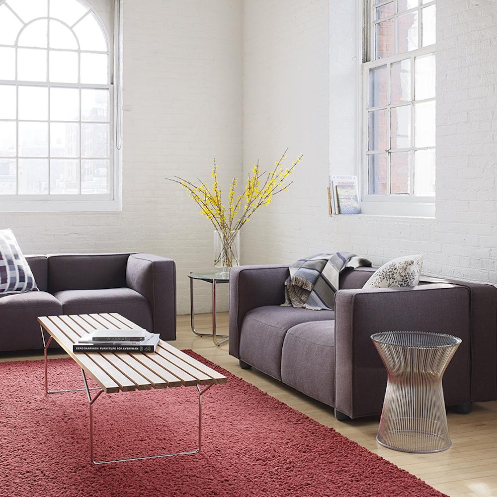 Knoll Bertoia Bench in room with Barber Osgerby Sofas and Platner Side Table