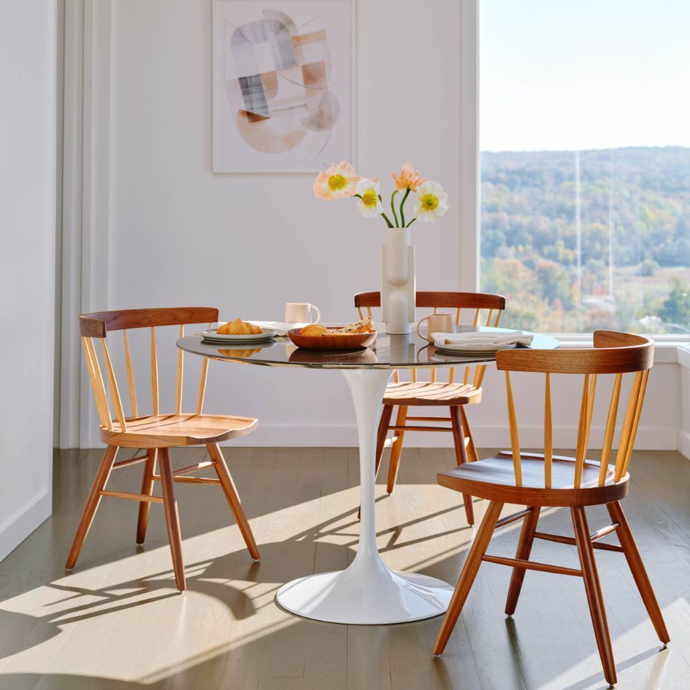 Knoll Nakashima Straight Chairs with Saarinen Dining Table and Fresh Flowers