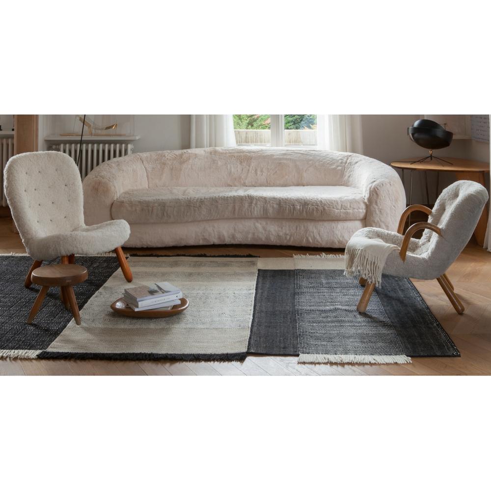 Nani Marquina Tres Rug in Room with Polar Bear Sofa