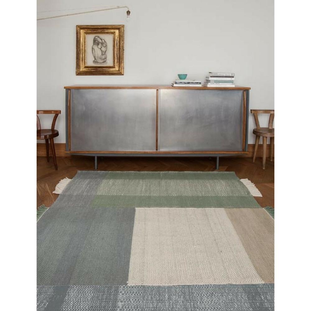 Nani Marquina Tres Rug Sage in room with zinc sideboard