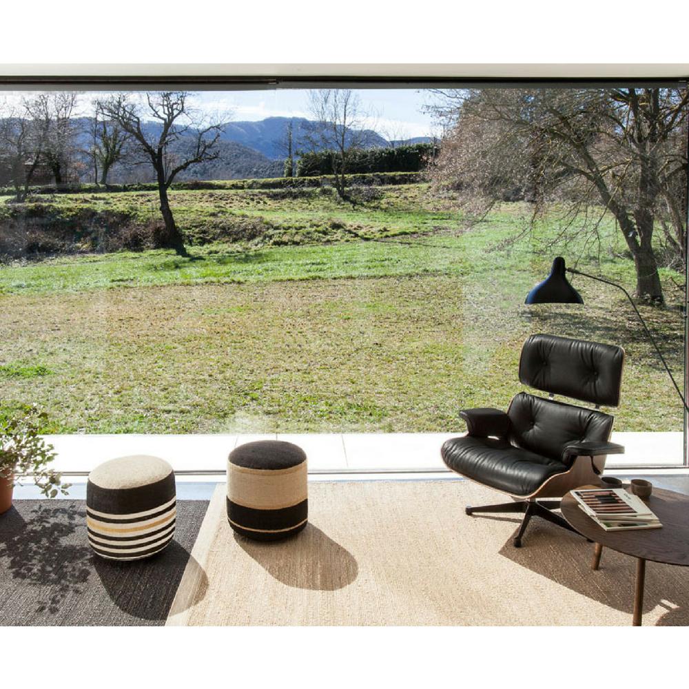 Nanimarquina Herb Rugs in room with Kilim Poufs, Eames Lounge, and Mantis Lamp