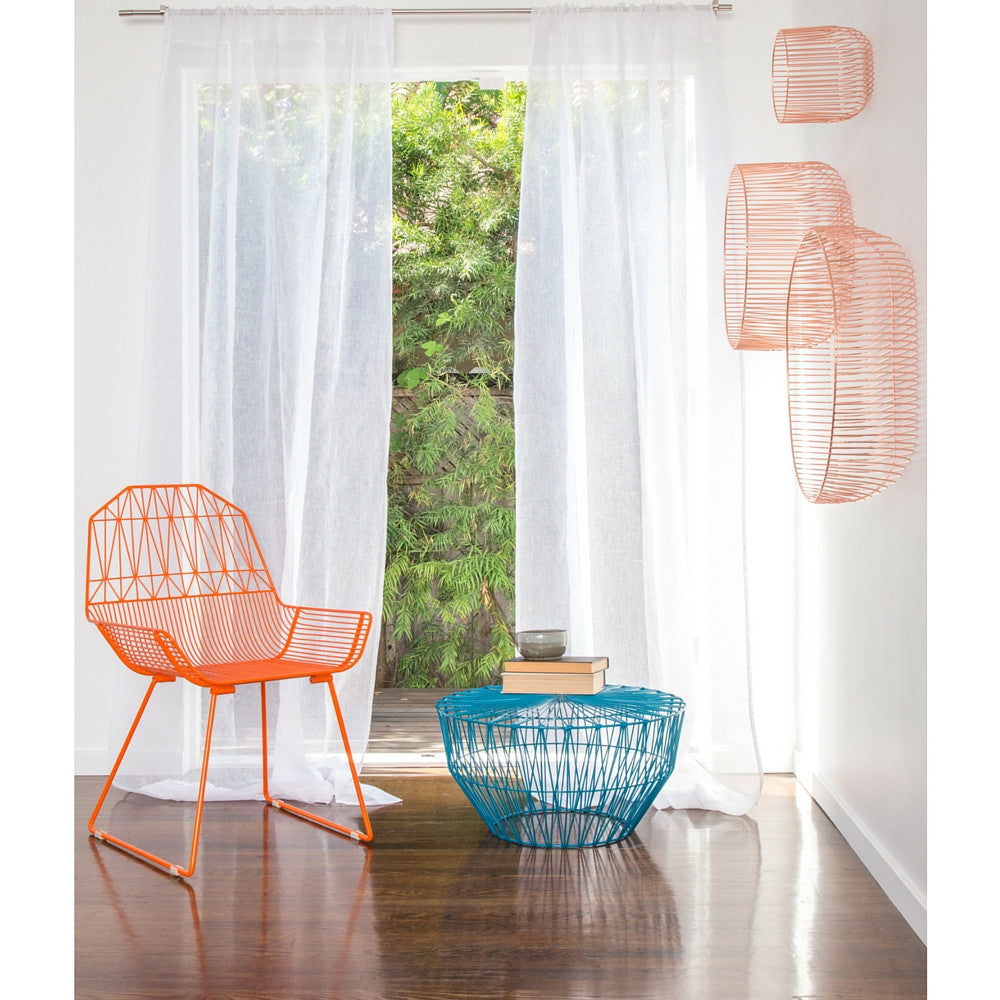 Bend Orange Farmhouse Chair in Room with Peacock Blue Drum Table