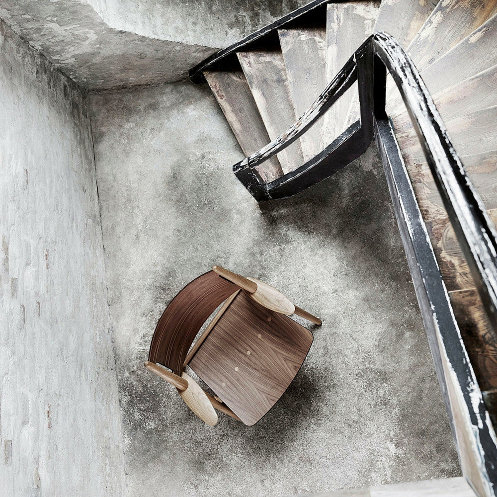 Wegner CH28 Sawhorse Chair Walnut and Oak in Room by Staircase Carl Hansen and Son