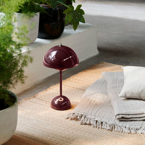 andTradition VP9 Flowerpot Lamp Deep Plum with Blanket and Plants