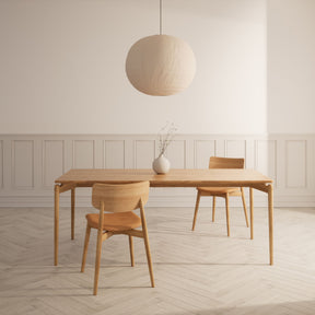 Bruunmunch Chiara Dining Chairs in Room with PURE Dining Table, Herringbone Floors and Paper Lantern