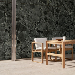 Carl Hansen BK10 Teak Dining Chairs and BK15 Teak Dining Table outdoors by Verdi Alpi Marble Wall