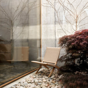 Carl Hansen Cuba Outdoor Chair Teak with Sesame Rope MG501 in Stony Courtyard by Japanese Maple tree