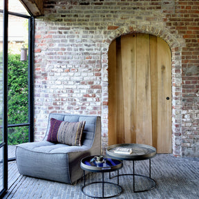 Ethnicraft N701 Sofa Chair in Light-Filled Room with Exposed Brick