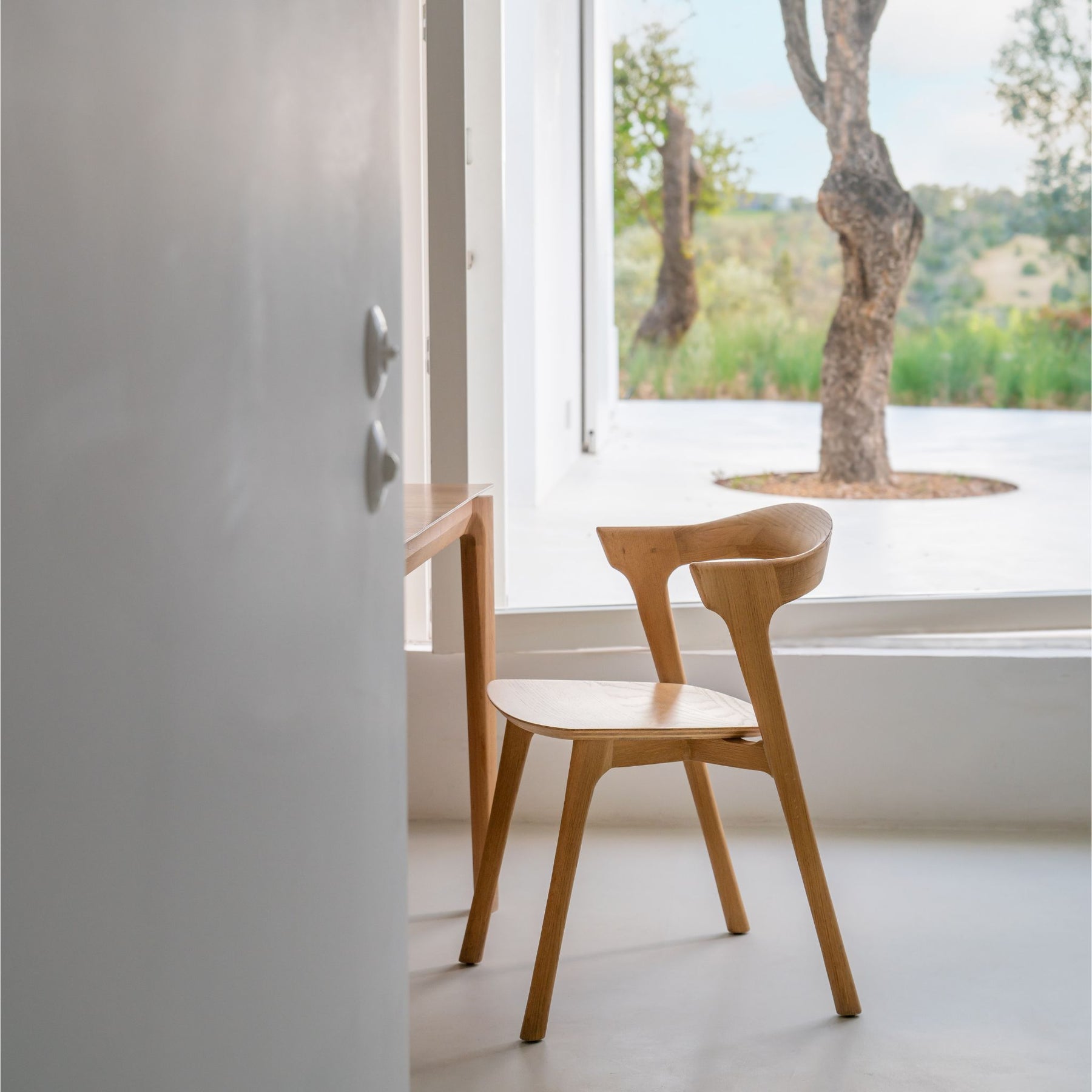 Ethnicraft Oak Bok Chair at Table by Window