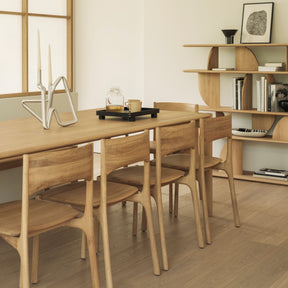 Ethnicraft Pi Dining Chairs and Pi Dining Table in room with Geometric Shelves