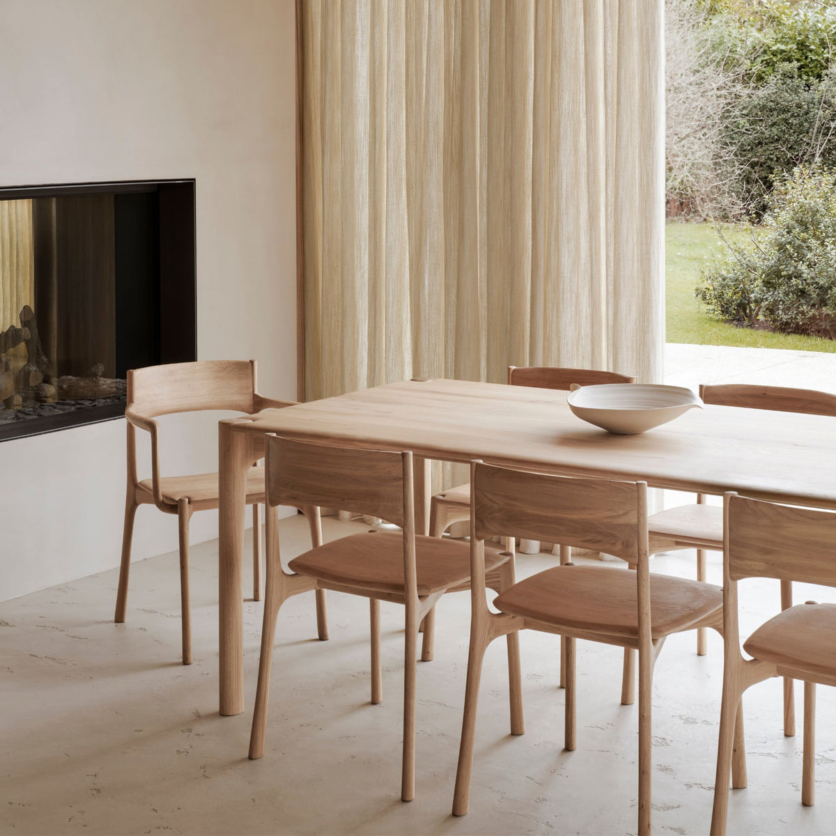 Ethnicraft Pi Dining Table and Chairs in room with Fireplace