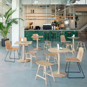 Ethnicraft Oak Torsion Cafe Tables Square and Round in Coffee Shop with Osso Stools and Facette Chairs
