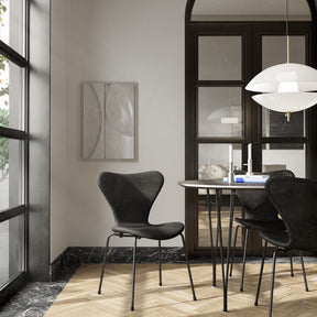 Fritz Hansen Clam Pendant Opal Glass and Brass in Masculine Copenhagen Apartment with black leather Series 7 Chairs and Super Ellipse Table