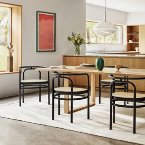 Fritz Hansen Clam Pendant in Dining Room with Essay Table and Poul Kjaerholm Caned Chairs