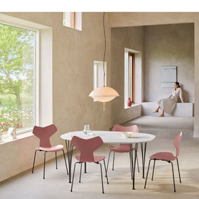 Fritz Hansen Clam Pendant Over Super Ellipse Table with Rose Grand Prix Chairs