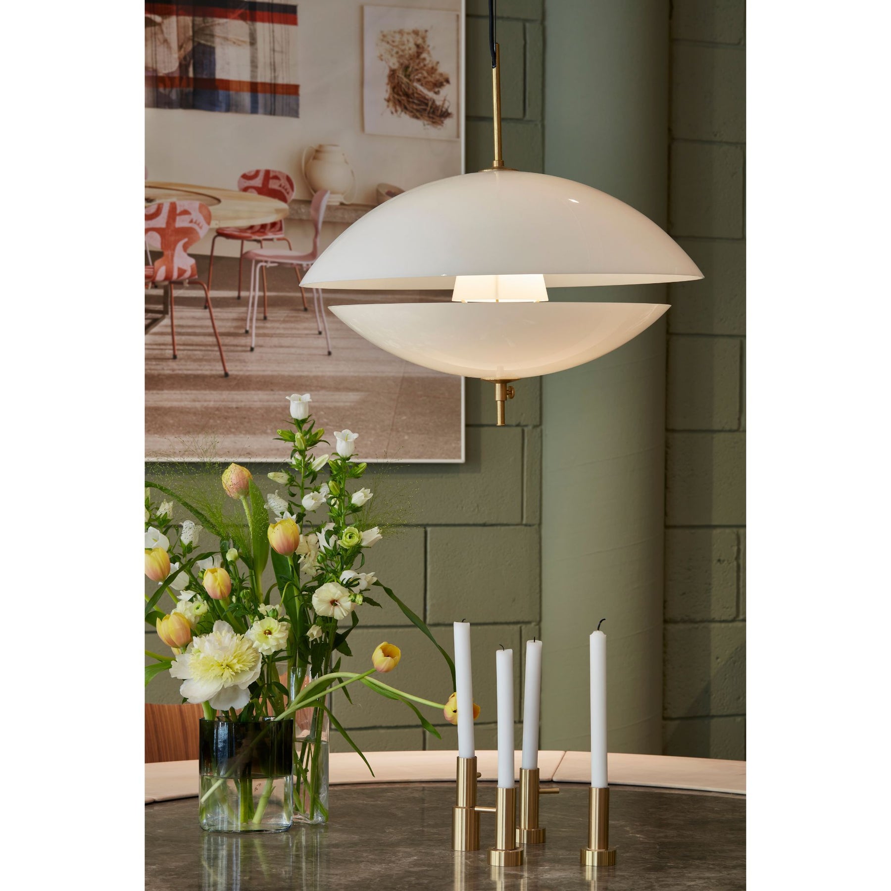 Fritz Hansen Clam Pendant Partially Open over Marble Table with Flowers and Candles
