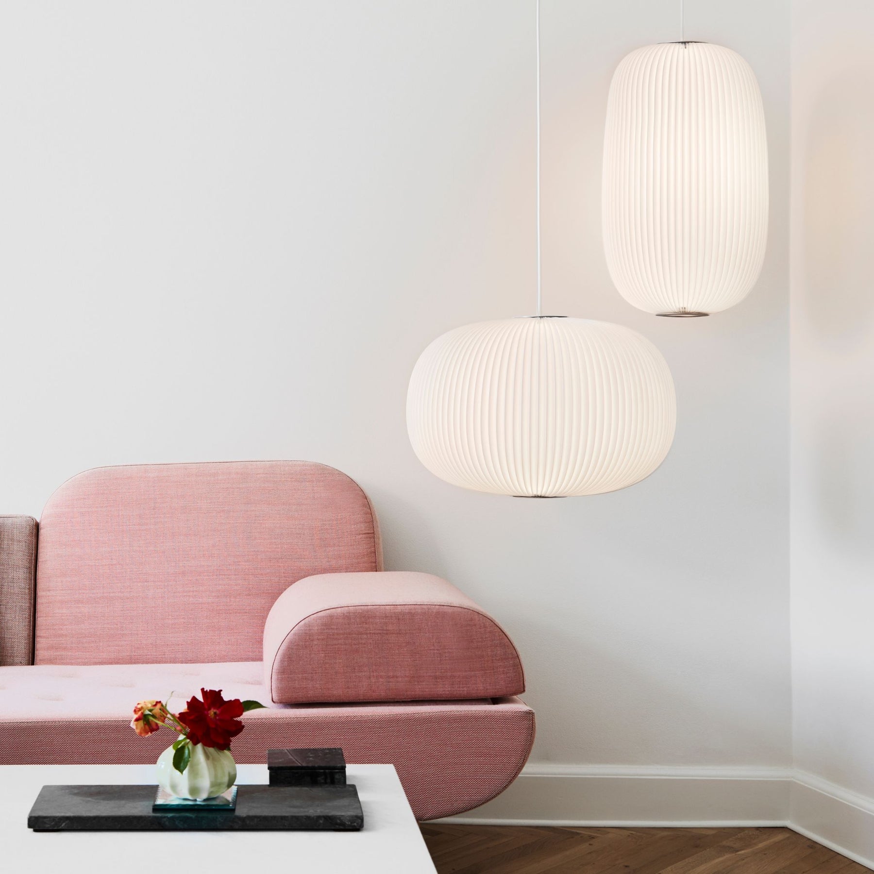 LeKlint Lamella Pendant Lights in Living room with pink wool sofa.
