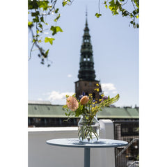 Muuto Linear Round Cafe Table Pale Blue with Flowers on Rooftop Deck in Copenhagen