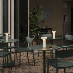 Muuto Linear Cafe Table and Chairs Dark Green on Brick Patio in Copenhagen