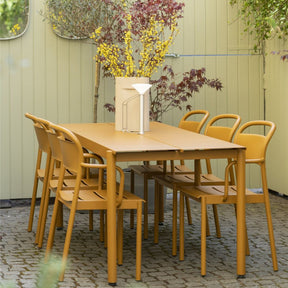 Muuto Linear Steel Dining Table and Chairs Burnt Orange on Stone Patio Copenhagen 3 Days of Design