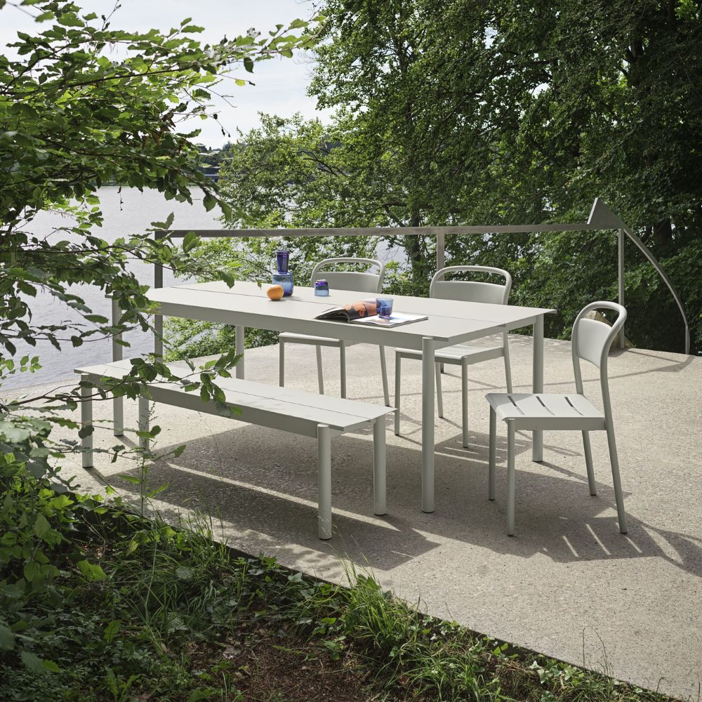 Muuto Linear Steel Side Chairs, Bench, and Table Outdoors by Lake