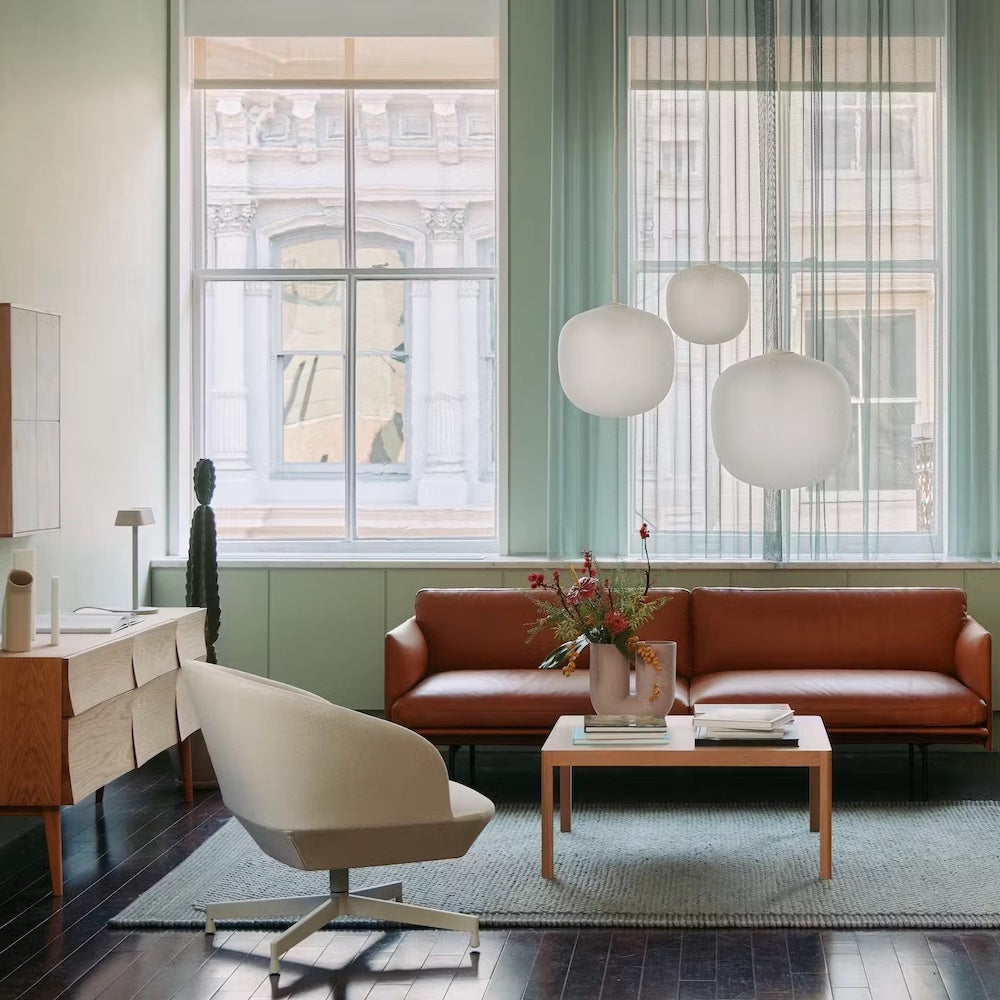 Muuto Outline Sofa in NY Apartment with Rime Pendants, Oslo Swivel Chair, Reflect Sideboard, Workshop Coffee Table, and Pebble Rug