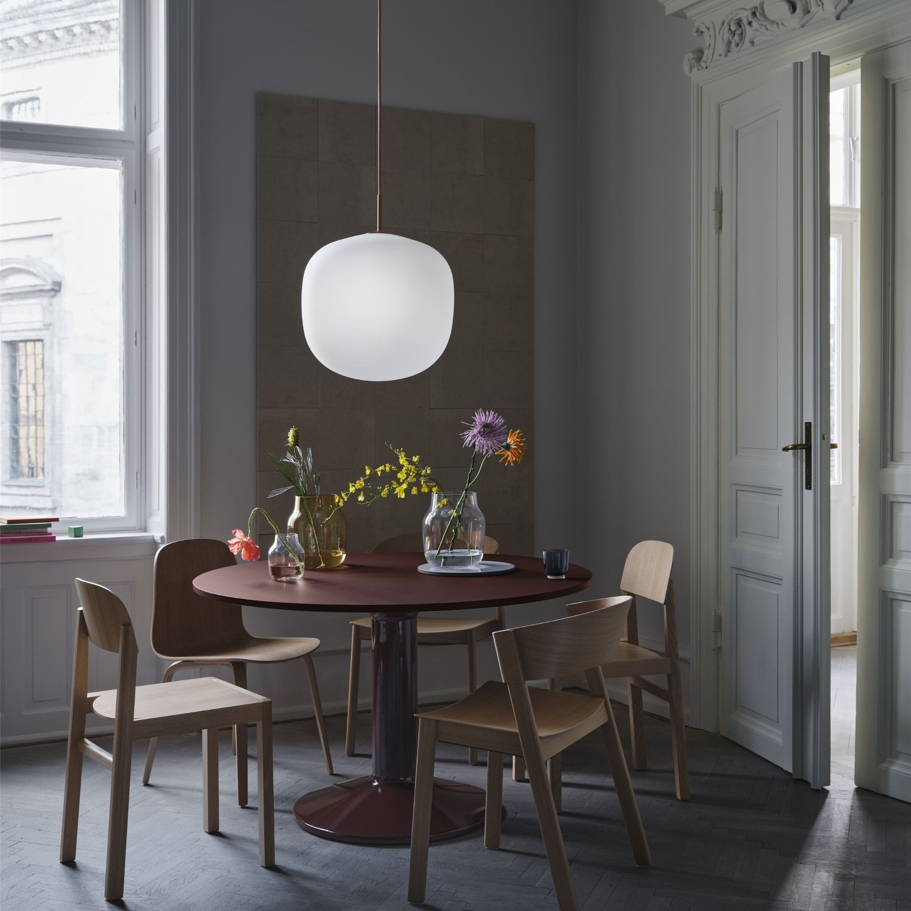 Muuto Rime Pendant Large over Dark Red Midst Dining Table in Copenhagen Apartment